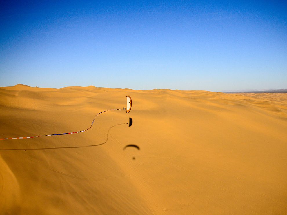  A paraglider photographed against a sand dune.jpeg